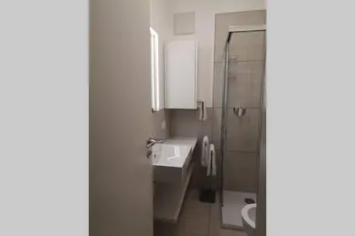 a bathroom with a sink and a shower and a toilet at Appartment Barbara in Bolzano