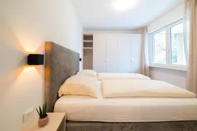 a bedroom with two beds and a window at CityPointApartments- Theatre in Merano
