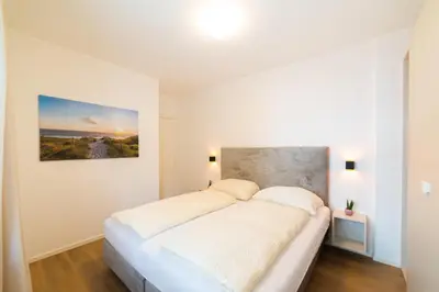 a white bedroom with a large bed in it at CityPointApartments- Theatre in Merano