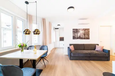 a living room with a couch and a table at CityPointApartments- Theatre in Merano