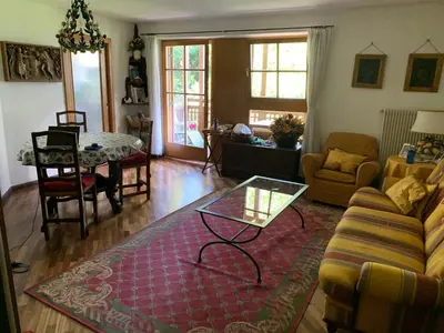a living room with a couch and a table at Siusi Sciliar Apartment in Siusi
