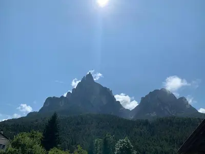 a view of a mountain range with trees and mountains at Siusi Sciliar Apartment in Siusi