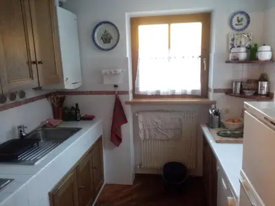 a small kitchen with a sink and a window at Siusi Sciliar Apartment in Siusi