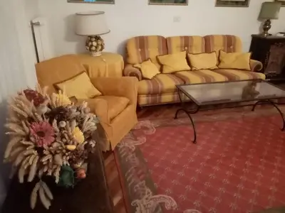 a living room with a couch and a table at Siusi Sciliar Apartment in Siusi