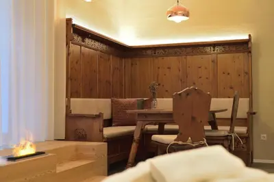 a dining room with a table and a fireplace at CityChalet romantic Bozen in Bolzano