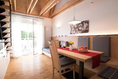 a dining room with a table with a bowl of fruit on it at Callhof - Bio Obsthof in Lana
