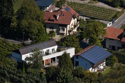 an aerial view of a house with a solar roof at Callhof - Bio Obsthof in Lana