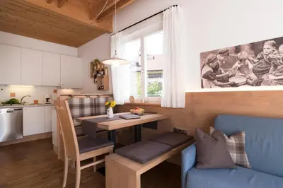 a kitchen and living room with a table and a dining room at Callhof - Bio Obsthof in Lana