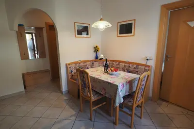 a dining room with a table and chairs and a table and chairsktop at Ferienwohnungen Luggin in Caldaro
