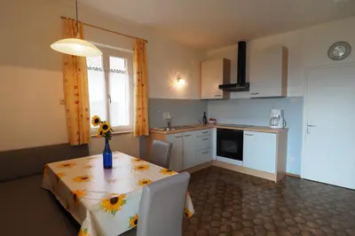 a kitchen with a table with a vase on it at Ferienwohnungen Luggin in Caldaro