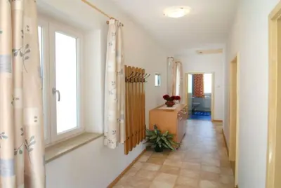 a hallway of a home with a window and a room at Ferienwohnungen Luggin in Caldaro