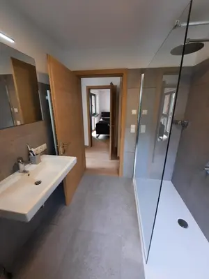 a bathroom with a sink and a shower at Luxury Apartment Daema in Selva di Val Gardena