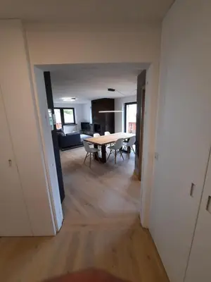 a view of a dining room and living room with a table at Luxury Apartment Daema in Selva di Val Gardena