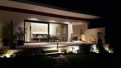 a house at night with a view of a living room at Zilli Studio Apartments in Termeno