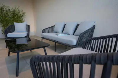 a living room with two chairs and a couch at Zilli Studio Apartments in Termeno