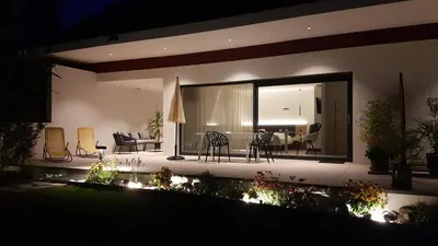 a house with a view of a patio at night at Zilli Studio Apartments in Termeno