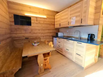 a small room with a bed and a window at Valles Vacanze - ski in & ski out in Falcade