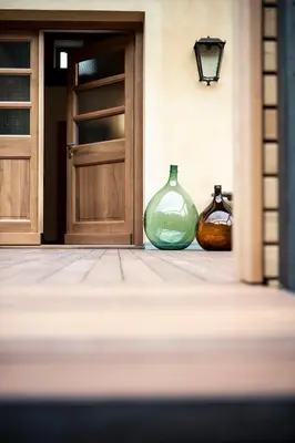 two glass vases sitting in front of a door at Weingut Kornell - Schafferhaus Cosmas und Zeder in Terlano