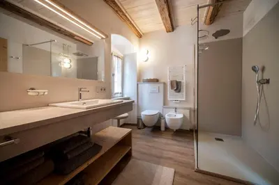 a bathroom with a sink and a toilet and a shower at Weingut Kornell - Schafferhaus Cosmas und Zeder in Terlano
