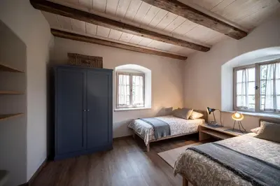 a bedroom with two beds and a blue cabinet at Weingut Kornell - Schafferhaus Cosmas und Zeder in Terlano