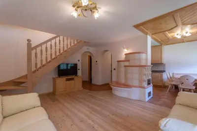 a living room with a staircase and a couch at Chalet Butterfly 1 in Mazzin