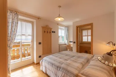 a bedroom with a bed and a large window at Chalet Butterfly 2 in Mazzin