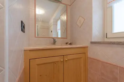 a bathroom with a sink and a mirror at Chalet Butterfly 2 in Mazzin