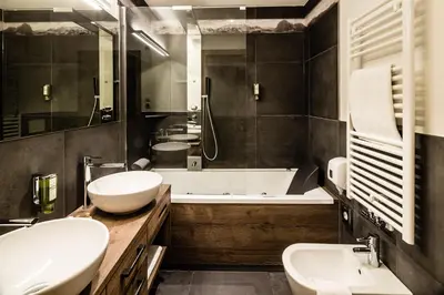 a bathroom with two sinks and a bath tub at Apartments Villa Gardena - Gardenahotels in Selva di Val Gardena