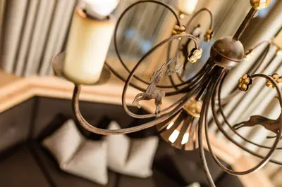 a close up of a candle on a chandelier at Apartments Villa Gardena - Gardenahotels in Selva di Val Gardena