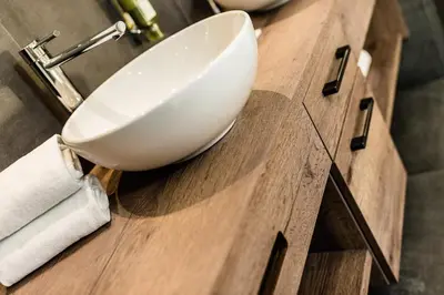 a white sink on a wooden counter in a bathroom at Apartments Villa Gardena - Gardenahotels in Selva di Val Gardena