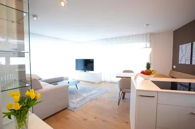 a kitchen and living room with yellow flowers in a room at Residenz Hofer in Naturno