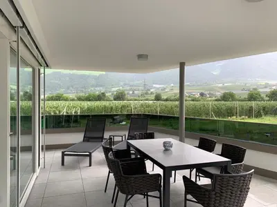 a patio with a table and chairs on a balcony at Residenz Hofer in Naturno