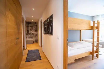 a room with a bunk bed and a hallway at Residenz Hofer in Naturno