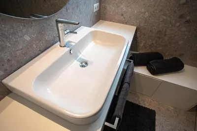 a white sink in a bathroom with a mirror at Residenz Hofer in Naturno