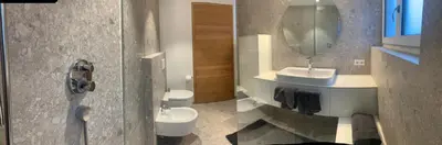 a bathroom with a toilet and a sink and a mirror at Residenz Hofer in Naturno