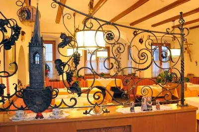 a room with two chairs and a table and a mirror at Roter Adler in Caldaro