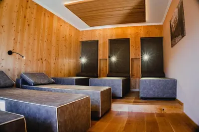 a waiting room with benches and wooden walls at Dolomitenhotel Weisslahnbad in Tires