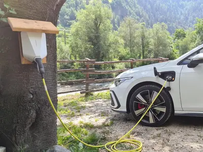 a car is hooked up to a tree with a yellow hose at Chalet Passeier - RIVER in Saltusio