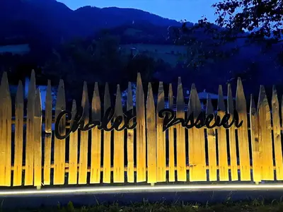 a wooden fence with the writing on it at Chalet Passeier - RIVER in Saltusio