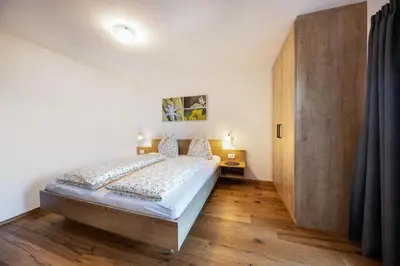 a bedroom with a bed and a wooden door at Gfliererhof in Fiè