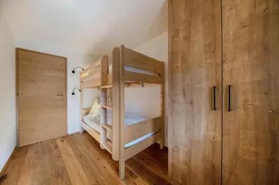 a bedroom with two bunk beds and a closet at Gfliererhof in Fiè