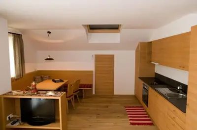 a kitchen with a table and a dining room at Wegmacherhof in Castelrotto