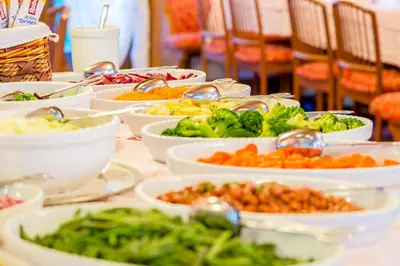 a table with many plates of food on it at Hotel Monte Civetta in Alleghe