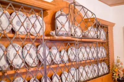 a shelf full of cups and plates on display at Hotel Monte Civetta in Alleghe