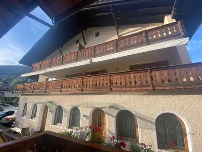 a building with a wooden balcony on top of it at Saskia Residence in Ortisei