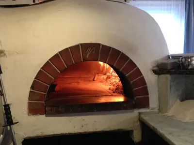 a brick oven with a fire inside of it at Saskia Residence in Ortisei