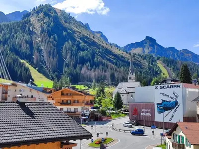 a view of a town with a mountain in the background at Albergo Pensione Sport in Arabba