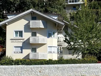 a white building with balconies on the side of it at Residence Isarcus in Bressanone