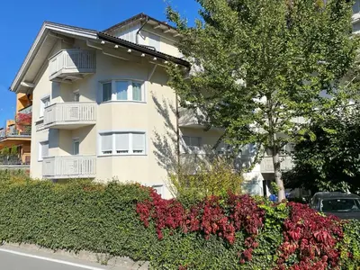 a apartment building with flowers in front of it at Residence Isarcus in Bressanone