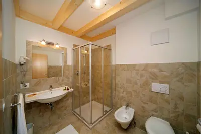 a bathroom with a sink and a shower and a toilet at Gasthof Falger in Vollan